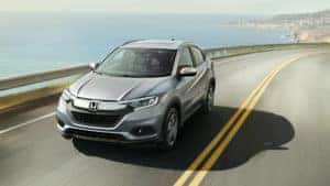 Grey 2022 Honda HR-V driving on a cliffside road