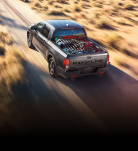 a honda ridgeline driving through a desert